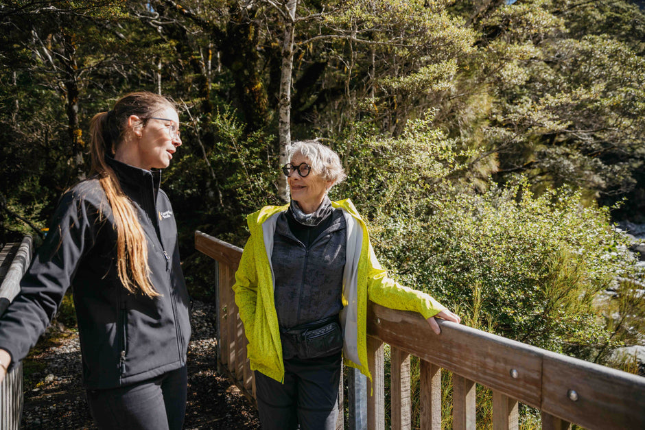 Guide Linda with guest, standing on bridge